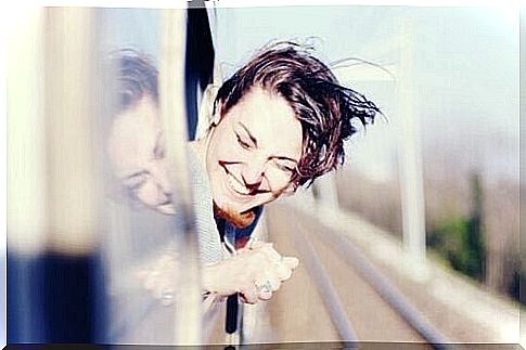 young woman by a train window