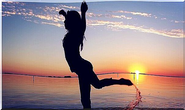 woman dancing at the beach