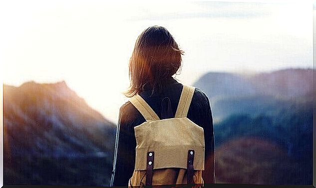 woman facing mountains