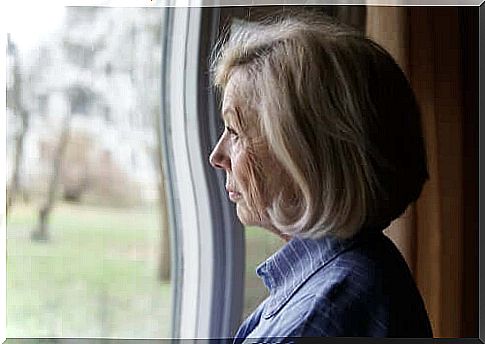 A thoughtful-looking lady looking out the window