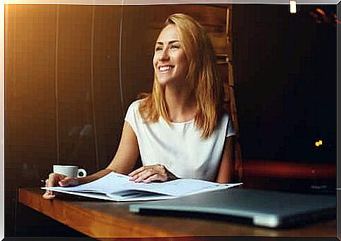 A woman who smiles at the office because she is building her vocation