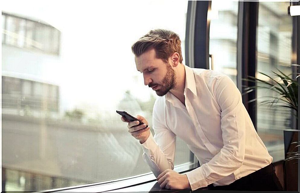 A man with a cell phone in his hand.