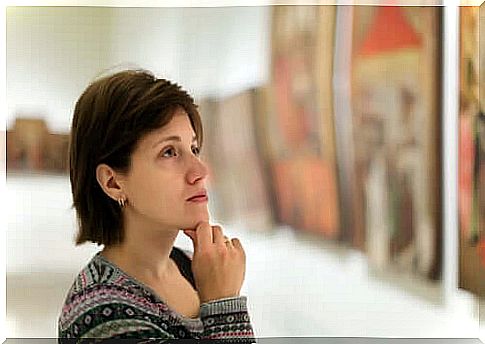 A woman observes a painting