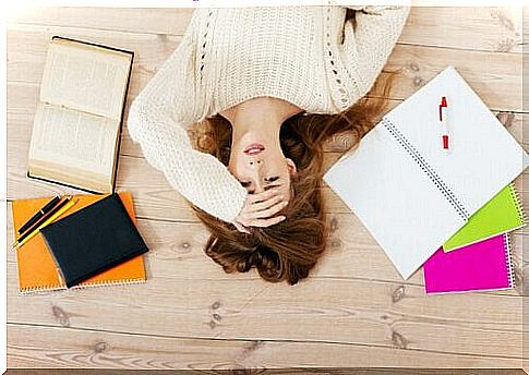 stressed woman in front of her notebooks