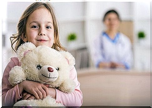 little girl holding a soft toy