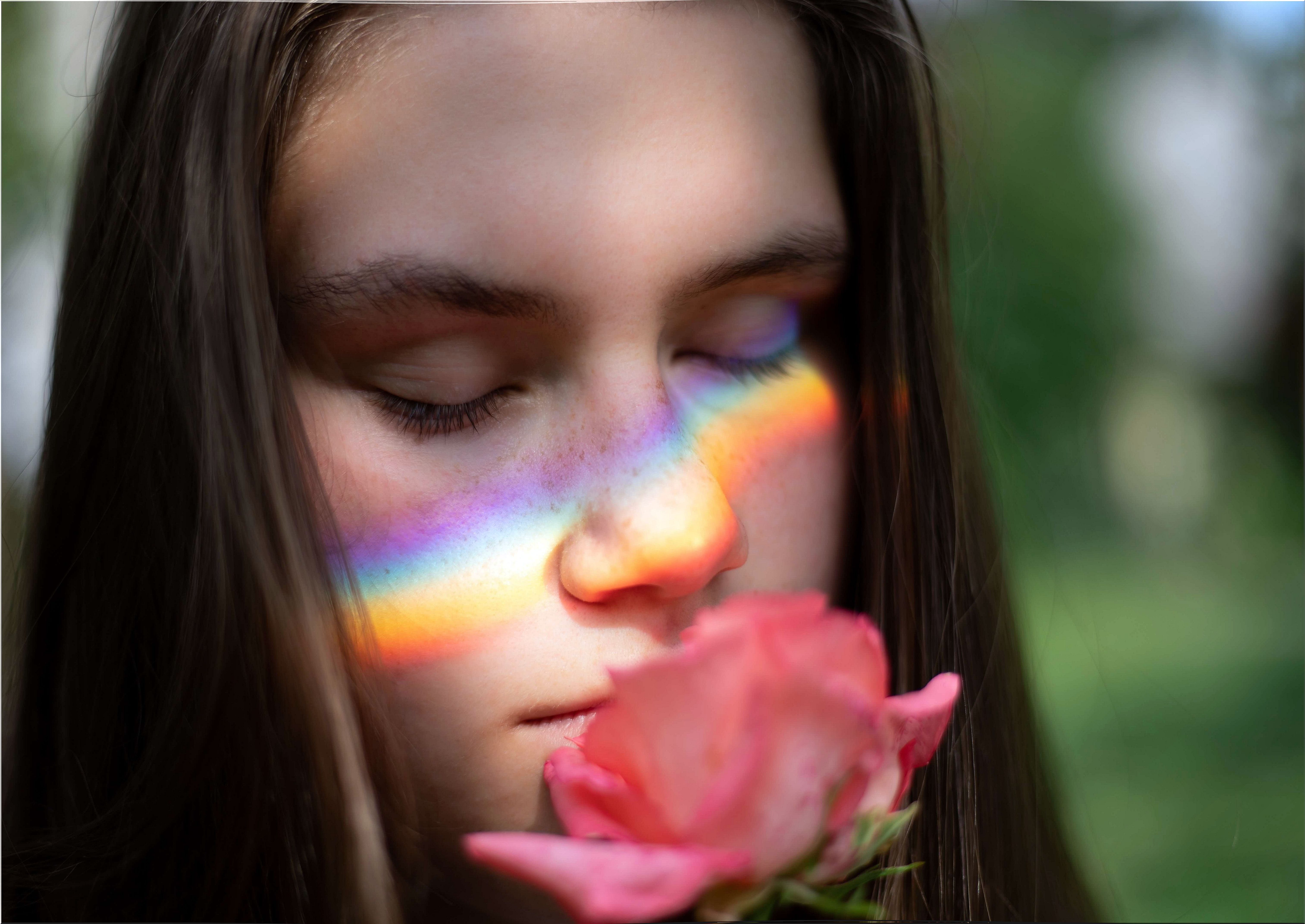 woman immersed in memories smelling a rose