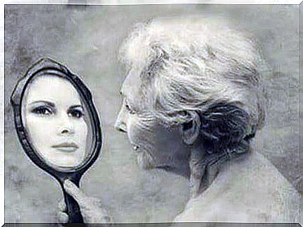 woman looking at herself in the mirror